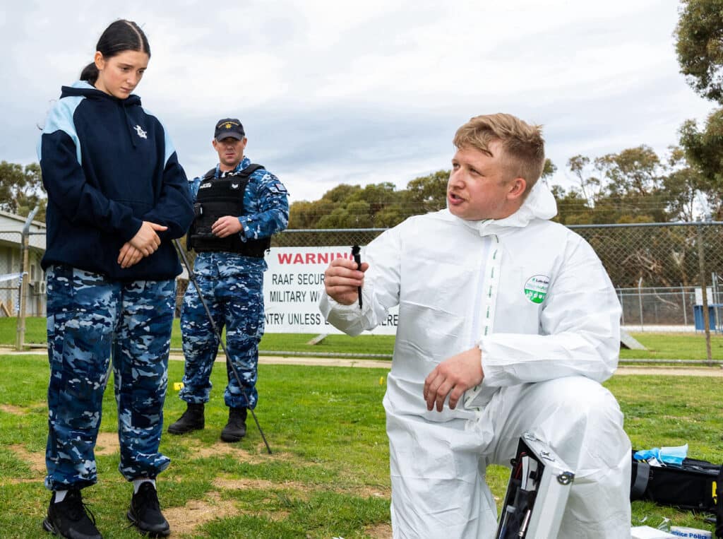 Joint Military Police Unit - Perth member, Corporal Kayden Price provides a demonstration of a crime scene investigation to Air Force Indigenous Youth Program participants at RAAF Base Pearce, Western Australia.