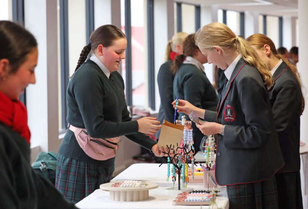 Students at the Women in Business Mother's Day Market with handmade products.